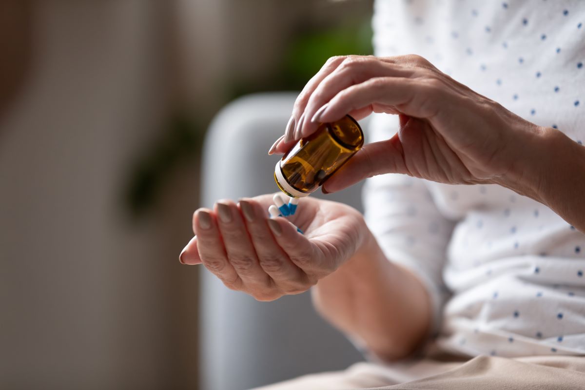 Person taking medication to deal with chronic disease