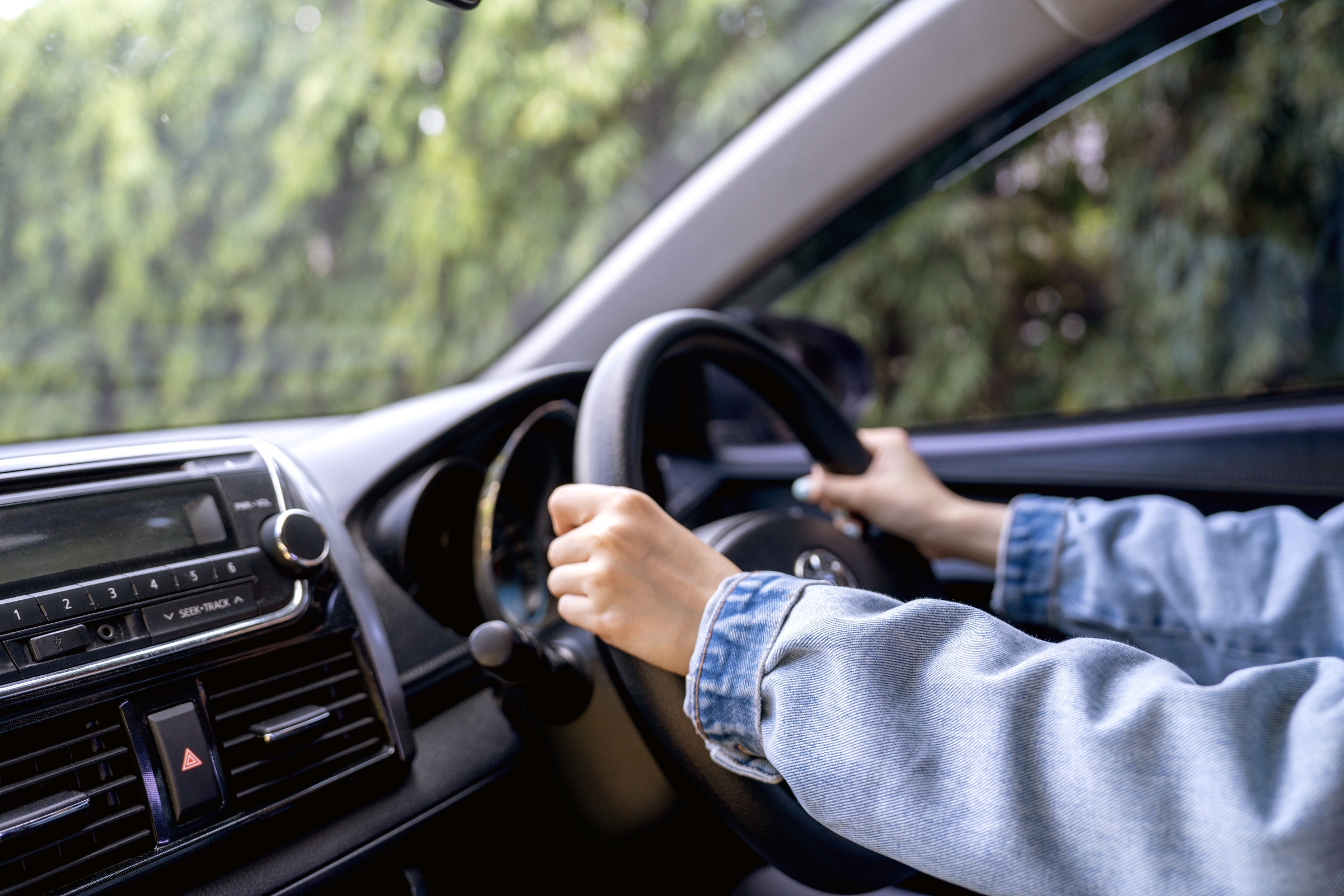 Woman driving the car in the morning on road