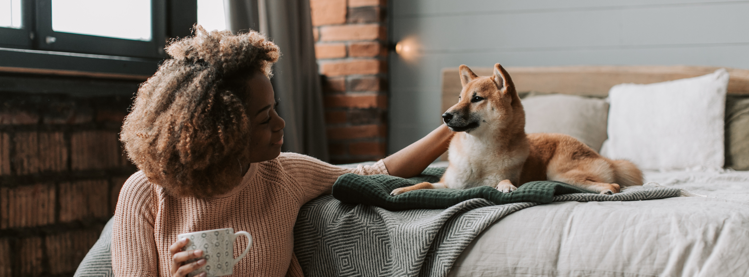 Pet owner relaxing at home with her dog, highlighting the peace of mind pet insurance provides for unexpected veterinary care.